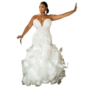 Elegant white strapless mermaid wedding dress with pearl beading and ruffled organza skirt
