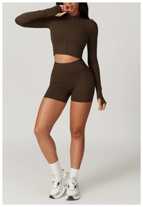 Detail view of deep brown yoga set featuring thumbhole cuffs and high-waist shorts