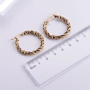 Detailed view of gold twisted hoop earrings with a 3cm ruler for size measurement