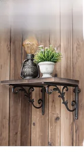 Detailed view of ornate cast iron shelf brackets supporting a heavy wooden board