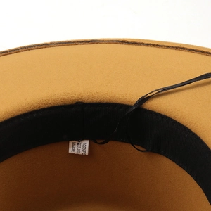 Macro detail of camel fedora inner lining with adjustable drawstring and care label