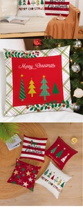 Detailed close-up of festive red and green Christmas pillow covers with plaid patterns