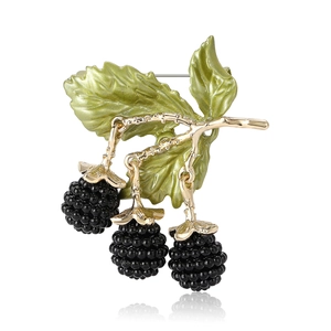 Creative enamel blackberry brooch with golden branches and green leaves on white background