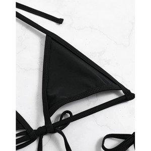 Classic black string bikini top with triangle cups and neck ties on marble backdrop