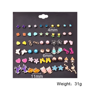 Set of 30 pairs of assorted stud earrings including hearts and animals on black card
