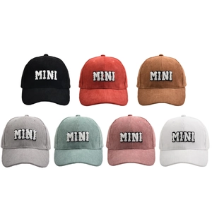 Multiple colors of corduroy baseball caps with MINI embroidery on white background