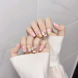 Pink handmade press-on nails with hand-painted floral patterns and 3D butterfly charms