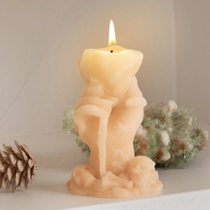 Gothic melting heart candle held by a skeleton hand, lit with a warm glowing flame