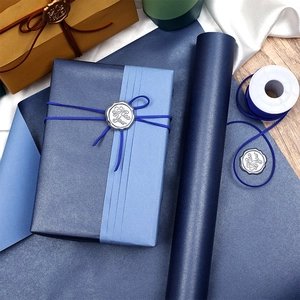 Double-sided blue gift wrapping paper roll with cotton twine and silver wax seal