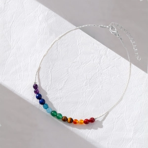 Macro detail of rainbow natural stone beads and 14K gold plated chain with lobster clasp