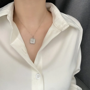 Silver butterfly shell pendant necklace with square design shown on model