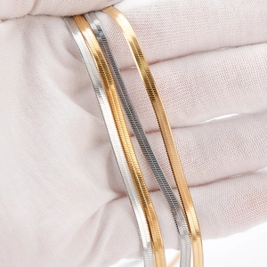 Flat stainless steel snake chain necklaces in gold, silver, and rose gold finishes