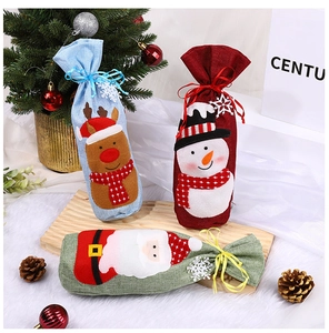Detail of Christmas wine gift bags with reindeer, snowman, and Santa applique patterns