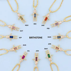 Gold robot pendants with colorful birthstones and sparkling cubic zirconia on light blue