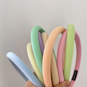 Close-up of handmade padded sponge headbands in soft macaron colors for daily styling