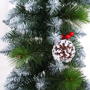 Christmas pine needle garland with white snow flocking, red berries and pine cones