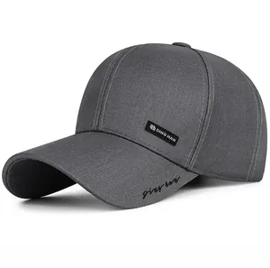 Detail view of dark grey baseball cap featuring side woven label and script embroidery