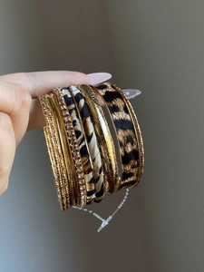 Detail view of 10pcs set leopard print and gold textured bangles with crystal accents
