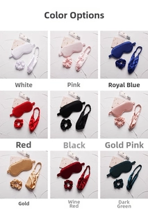 Silk-like sleep mask set with scrunchies in nine colors on a textured stone background