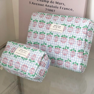 Quilted blue checkered cosmetic bags with pink tulip print and minimalist fabric label