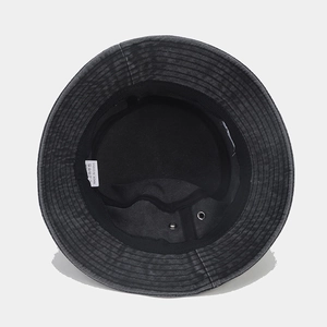 Detail of grey bucket hat interior with sweatband, metal eyelets and wash care label