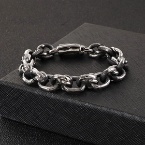 Detailed macro shot of vintage gunmetal square link chain bracelet for men on a black box
