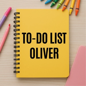 Top view of a bright yellow spiral notebook on a wooden desk with colorful pens
