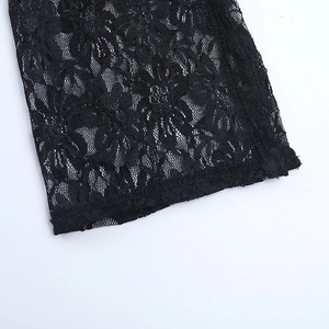 Close-up of black lace dress showing intricate floral crochet pattern and texture