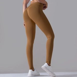 Detail of ginger yoga leggings with peach butt-lift seams and high-waisted crossover design