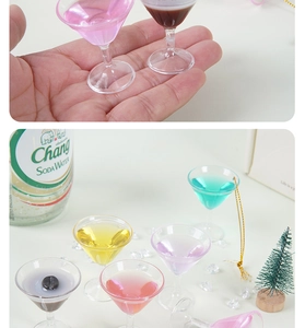 Detailed close-up of colorful miniature cocktail glass charms held to show micro size