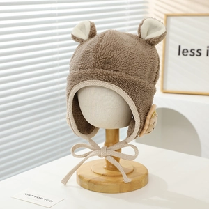Detail of cute lion plush ear-flap hat with warm wool texture and chin straps