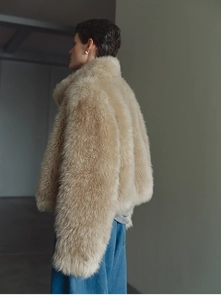 Detailed side view of beige long-hair faux fur vest showing plush texture and stand collar