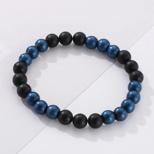 Detailed macro of 8mm matte black and metallic blue beaded elastic couple bracelet