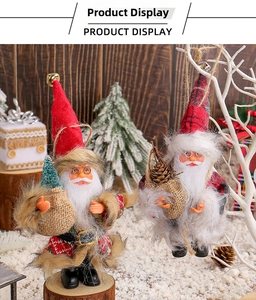 Detail of plush Santa figurines with Christmas tree and pine cones in cozy decor