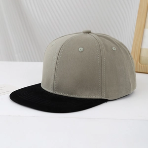 Close-up of kids two-tone snapback cap showing grey crown and black flat brim details