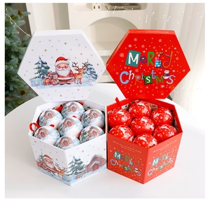 Detail of red and white hexagonal Christmas gift boxes with festive ball ornaments