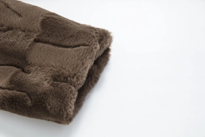 Macro shot of dark brown faux fur coat with distinct 3D grid textured pattern detail