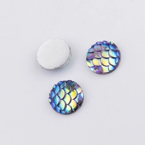 Close-up of 10mm iridescent fish scale resin cabochons with flat silver backing