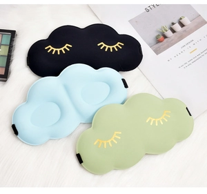 Detailed view of 3D cloud sleep masks in black, blue, and green with cute eyelash designs.
