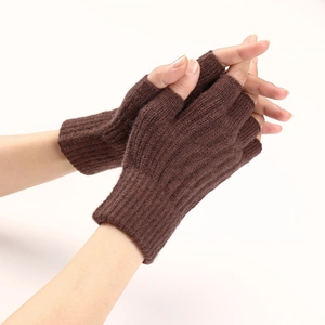 Detailed knit texture of brown cable-stitch fingerless gloves for autumn and winter warmth