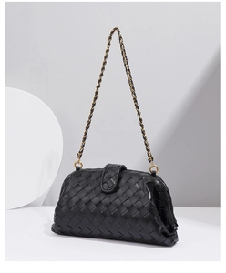 Close-up detail of the black woven leather shoulder bag showcasing exquisite craftsmanship.