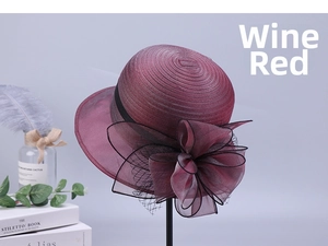Detail of wine red organza flower and mesh netting on elegant summer wide brim sun hat