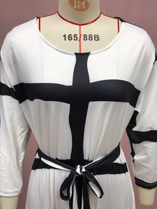 Detail of white dress featuring bold black cross stripes and adjustable waist tie