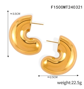 Detail view of large chunky gold C-shaped earrings with size and weight measurements