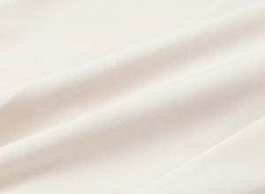 Texture macro del morbido tessuto a maglia crema con trama e dettagli di alta qualità