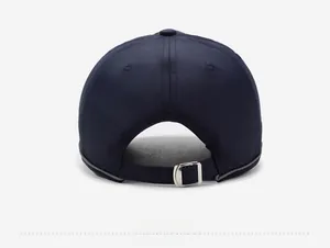 Detail view of the navy baseball cap back featuring an adjustable silver metal buckle