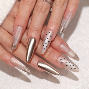 Champagne gold mirror and black polka dot press-on nails set in elegant almond shape