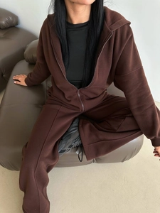 Detail of dark brown hooded sweatshirt and wide-leg joggers in soft cotton fleece