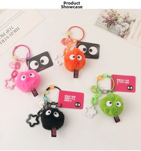 Macro shot of colorful plush soot sprite keychains with star charms and letter beads