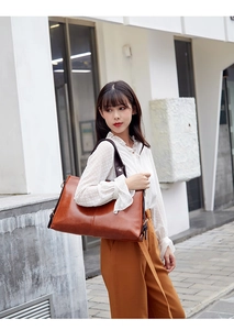 Elegant brown leather shoulder bag for women, large capacity commuter tote for daily work.